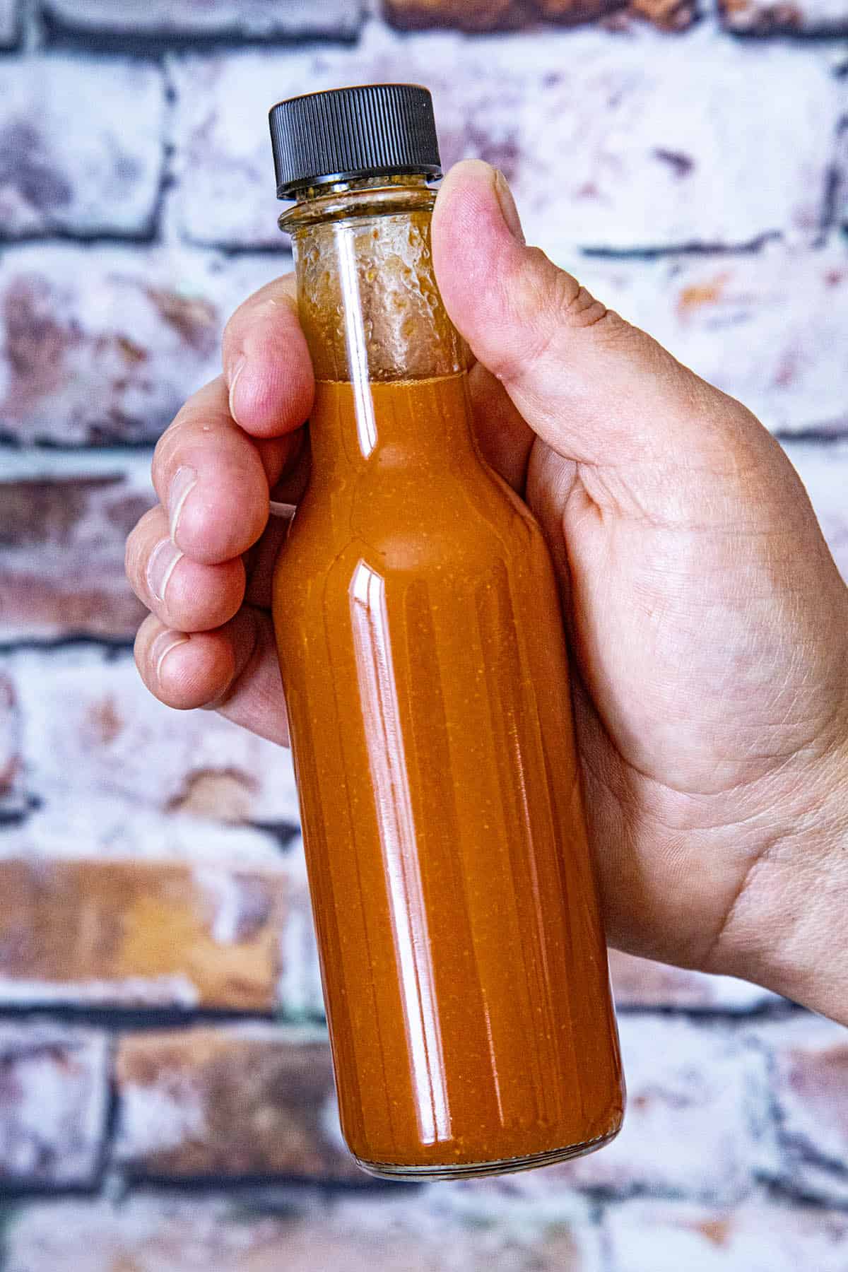 A bottle of spicy red hot sauce