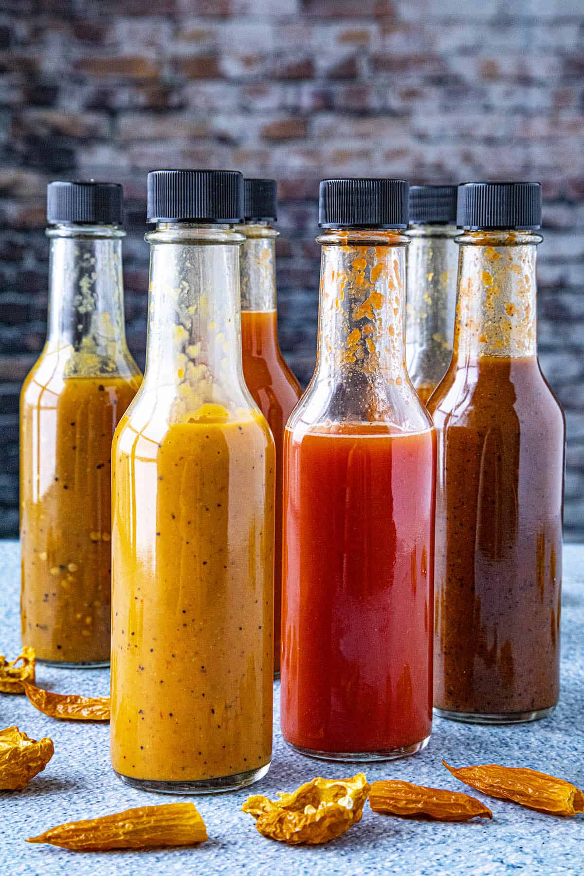 A large collection of hot sauces, each made from dried chili peppers