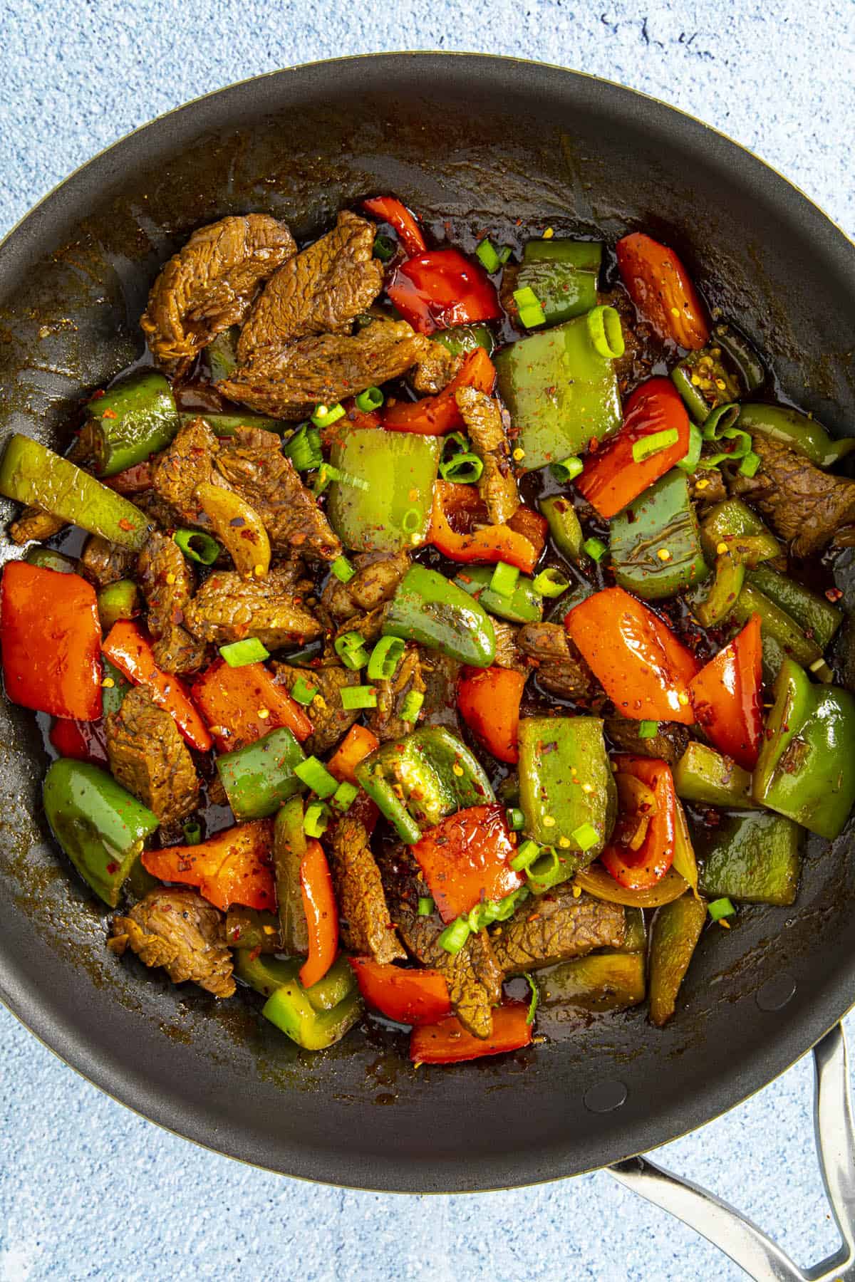 Pepper steak in a pan with garnish