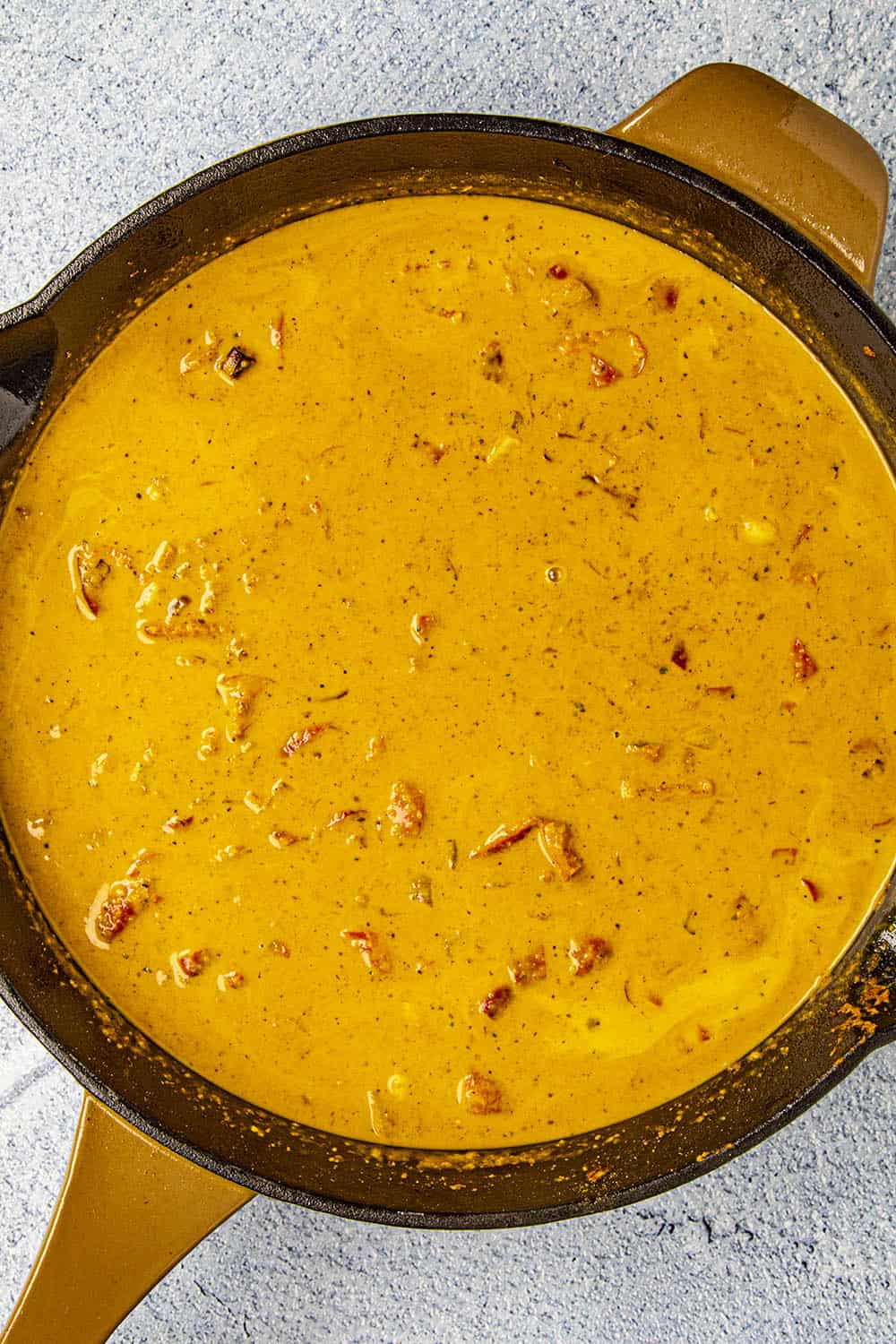 Adding the coconut milk to the pan.