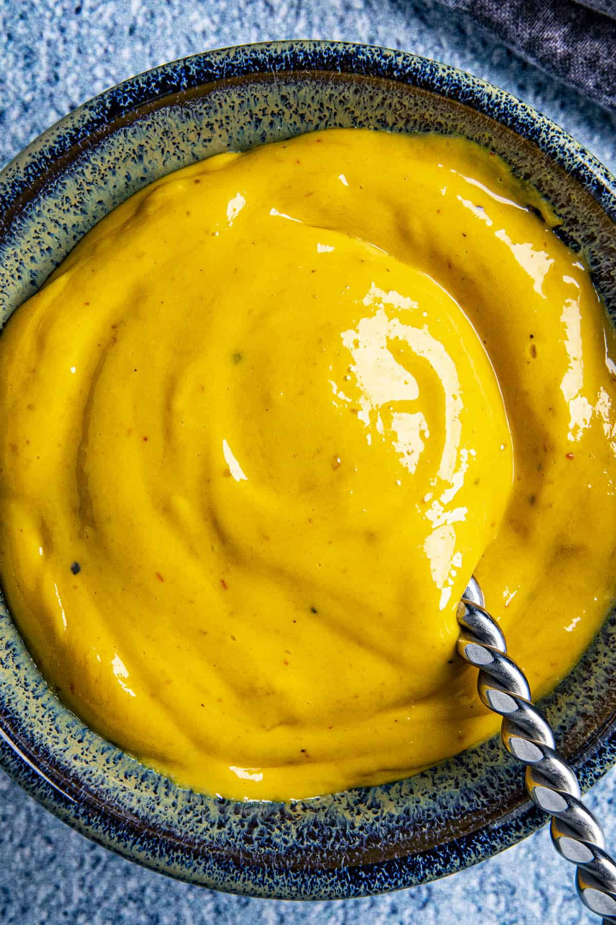 Thick and creamy sriracha aioli on a spoon