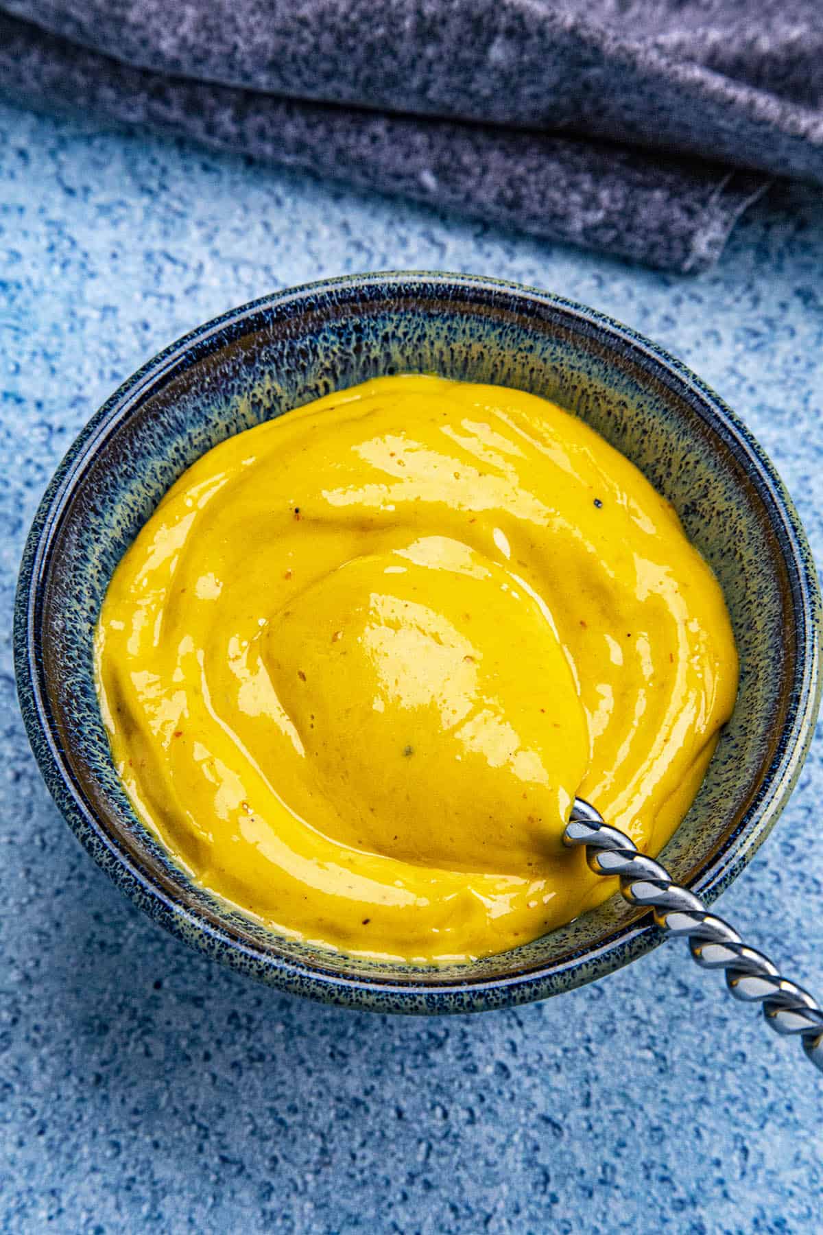 Sriracha Aioli in a bowl with a spoon, ready to serve