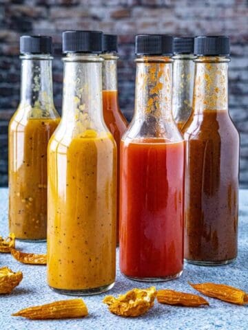 A large collection of hot sauces, each made from dried chili peppers