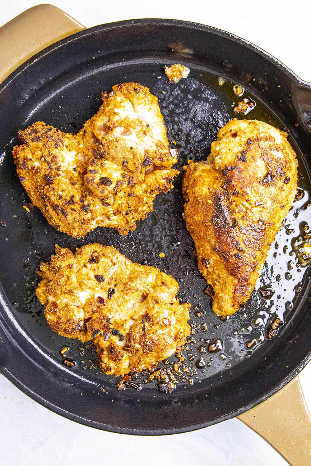 Seared chicken in a hot pan