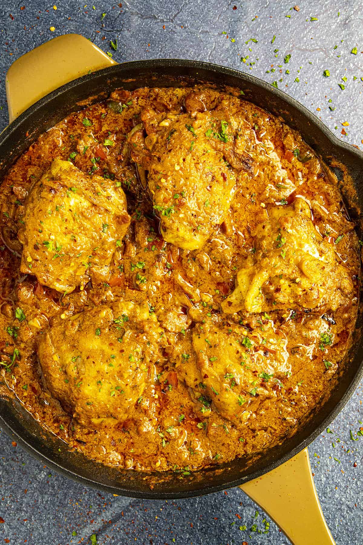 Chicken Paprikash in a hot pan, smothered in spicy sauce