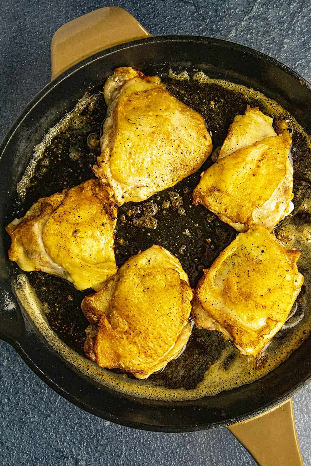 Browning and rendering the chicken thighs