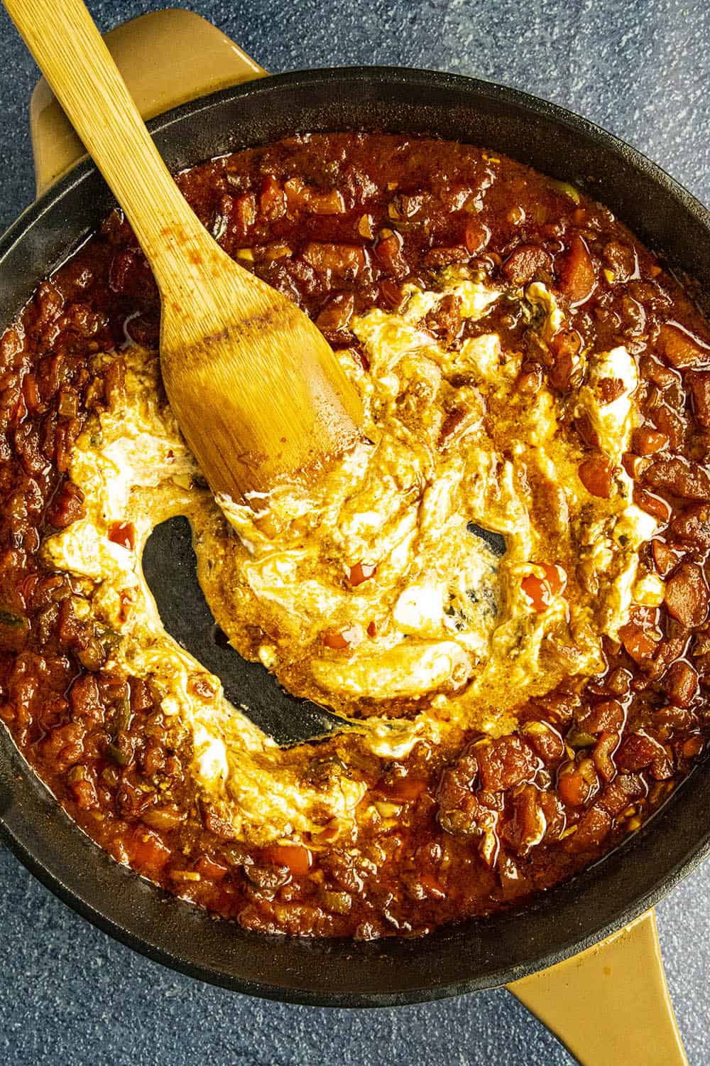 Swirling sour cream into the paprika sauce