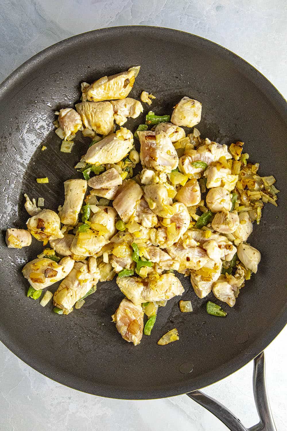 Cooking down the chicken and vegetables in a hot pan