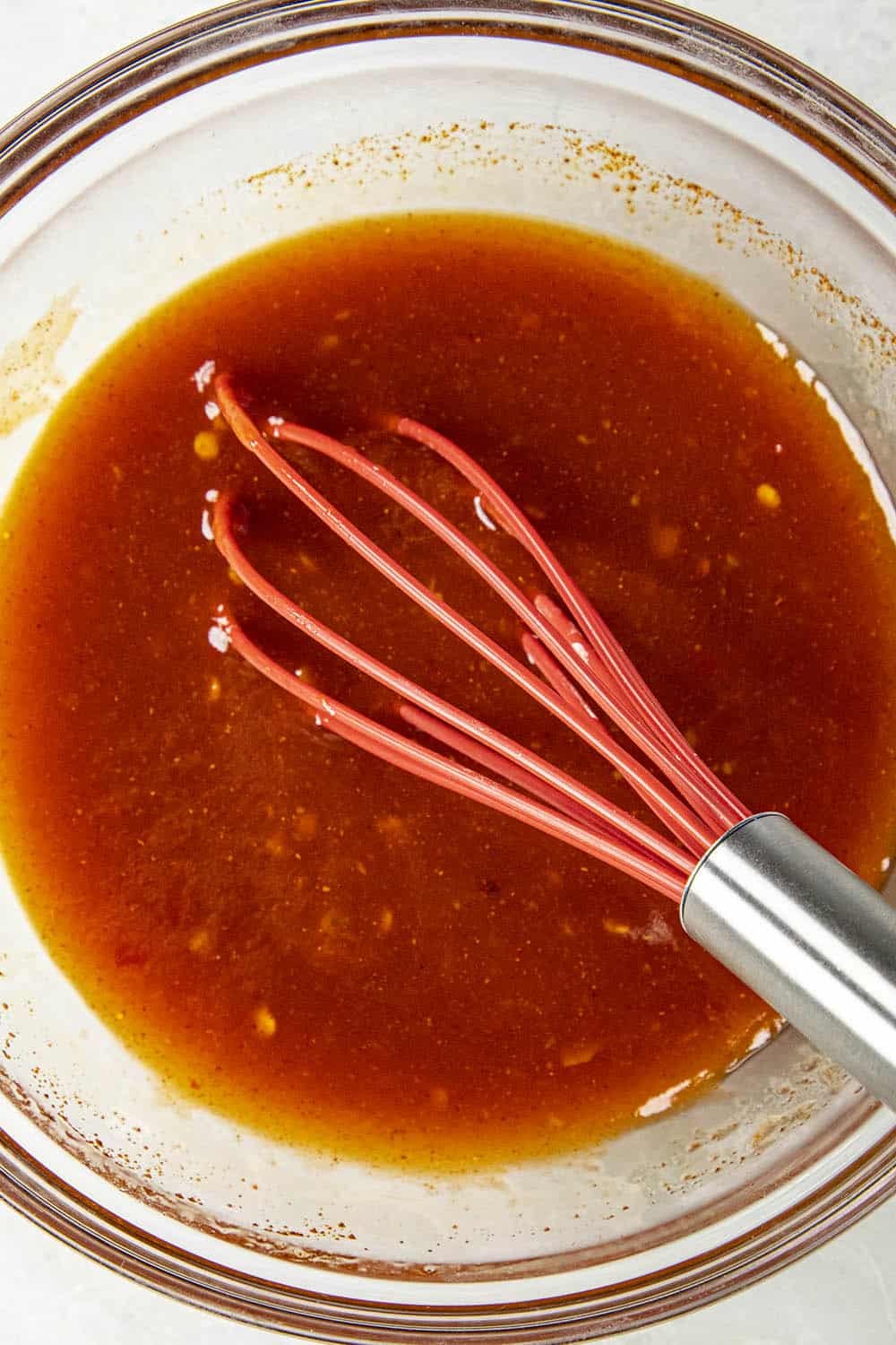 Whisking the firecracker shrimp marinade in a bowl