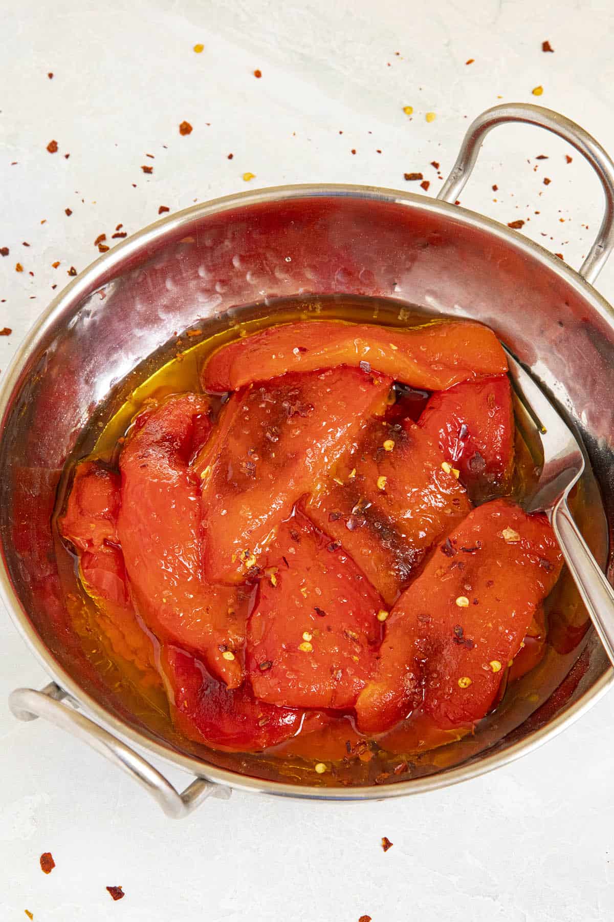Roasted Red Peppers in a bowl with lots of olive oil