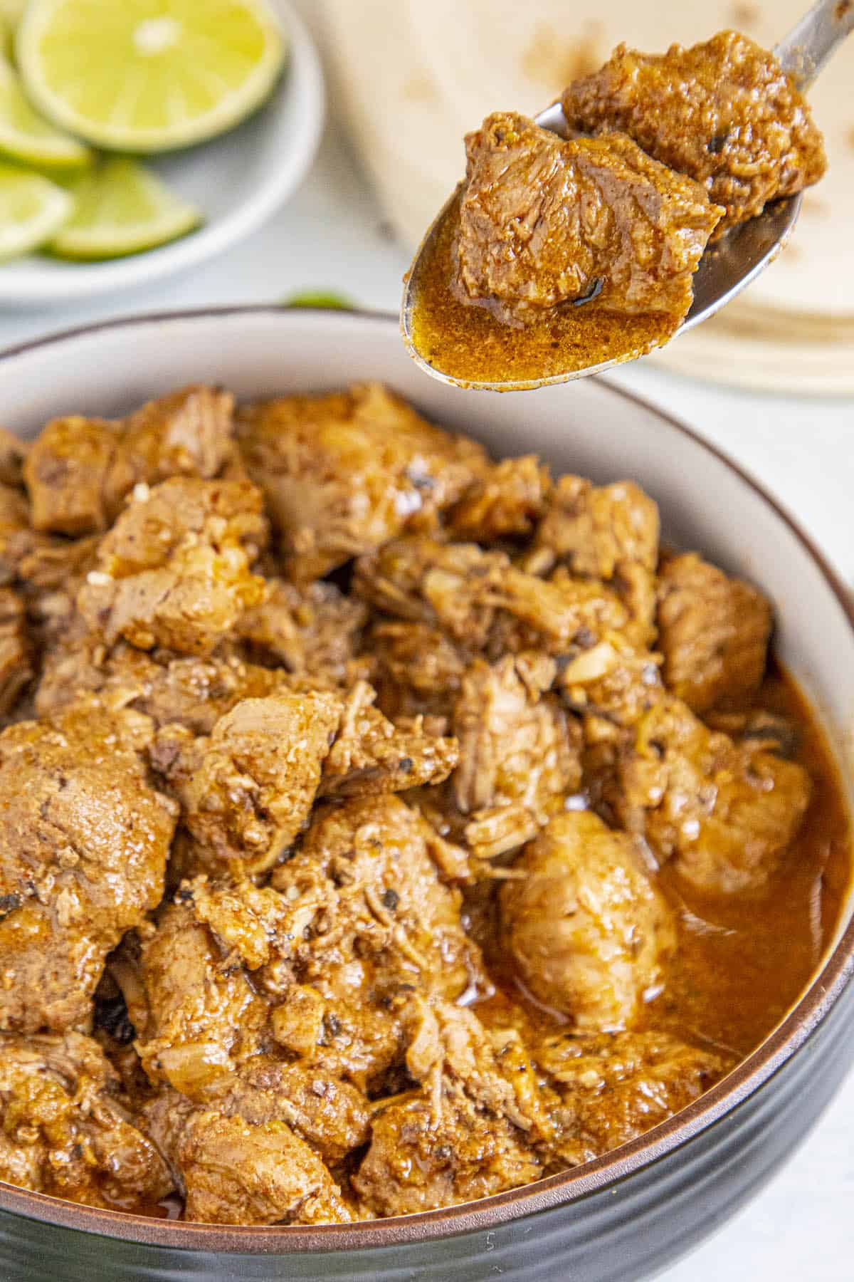 Chunky pieces of Carne Adovada on a spoon