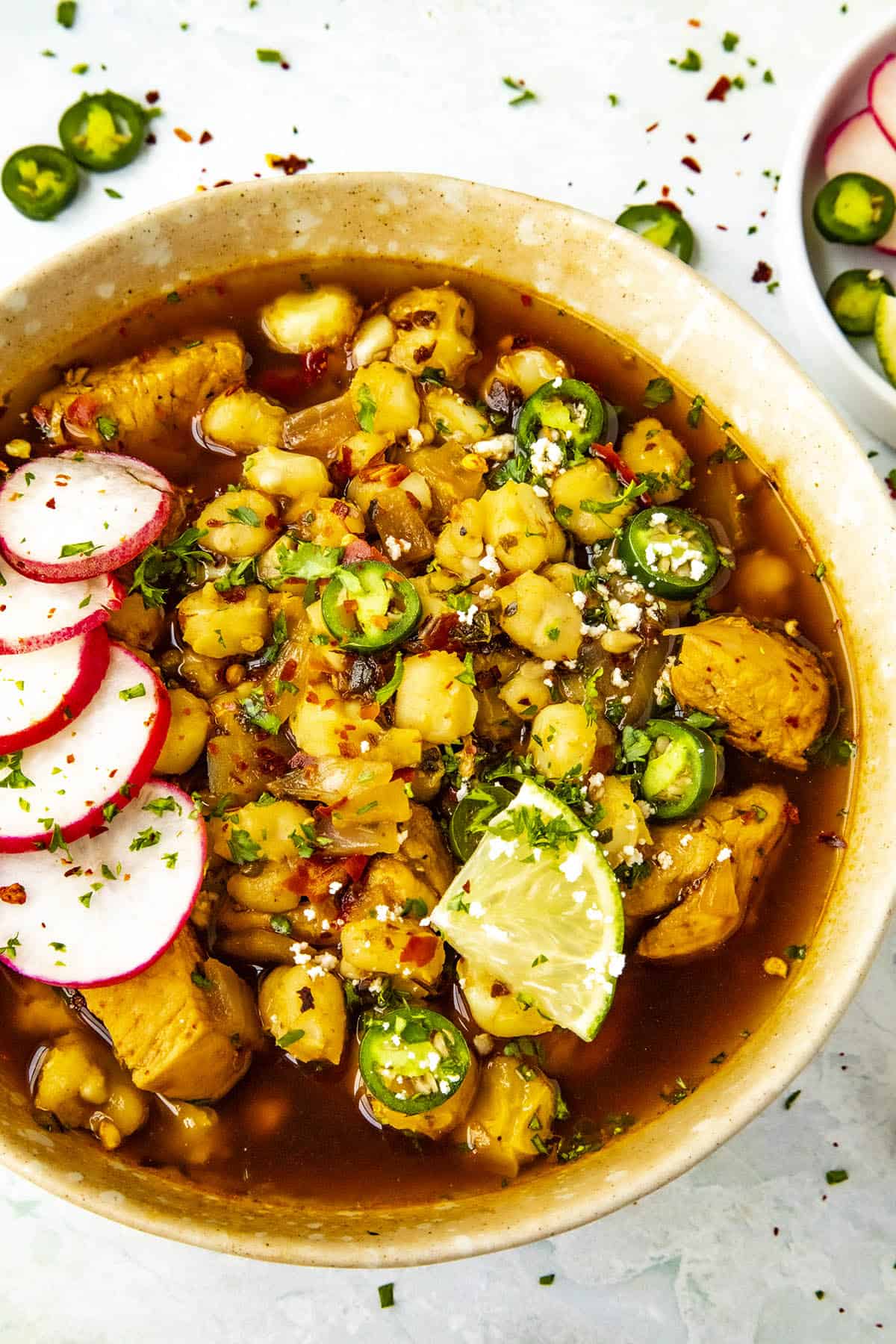 Chicken Pozole Rojo in a bowl with lots of hominy