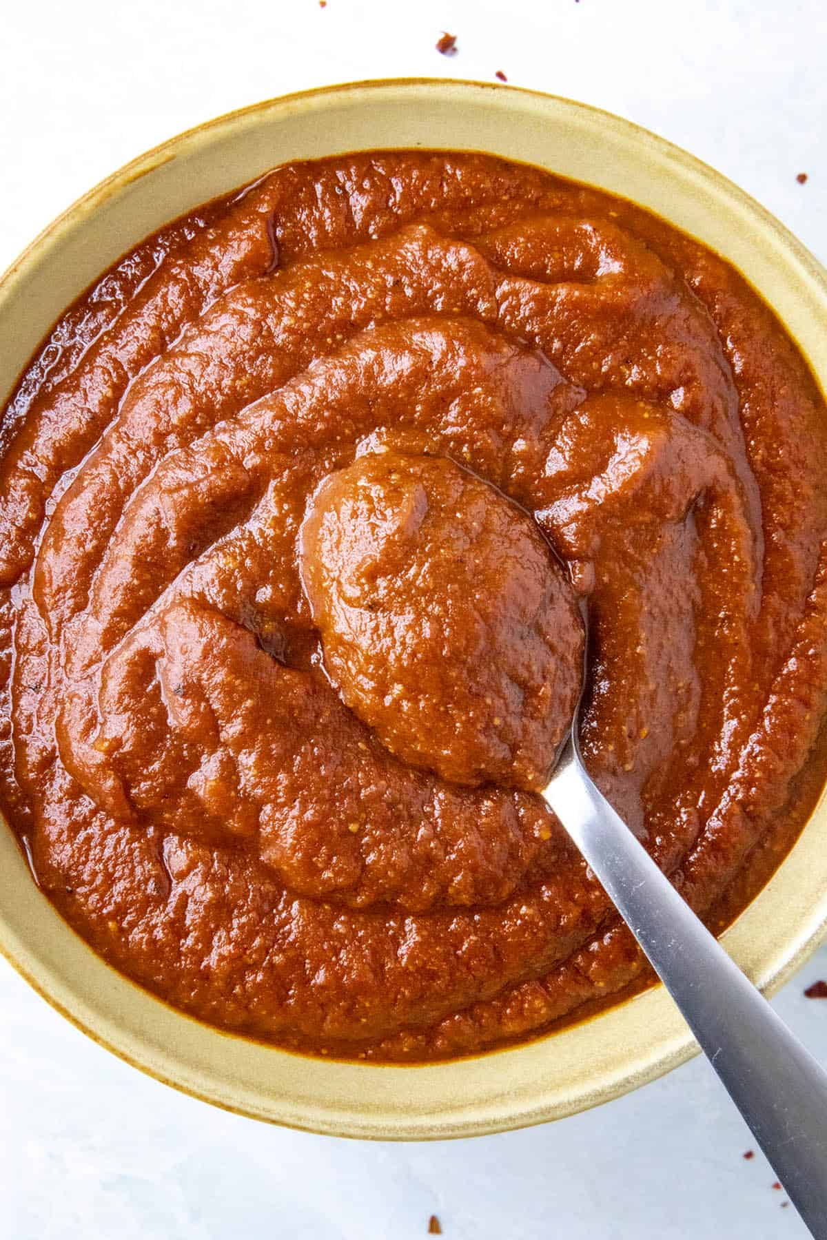 Thick and Rich Red Enchilada Sauce on a spoon