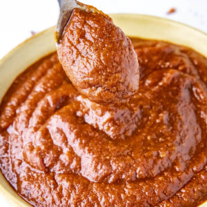 Homemade Red Enchilada Sauce on a spoon