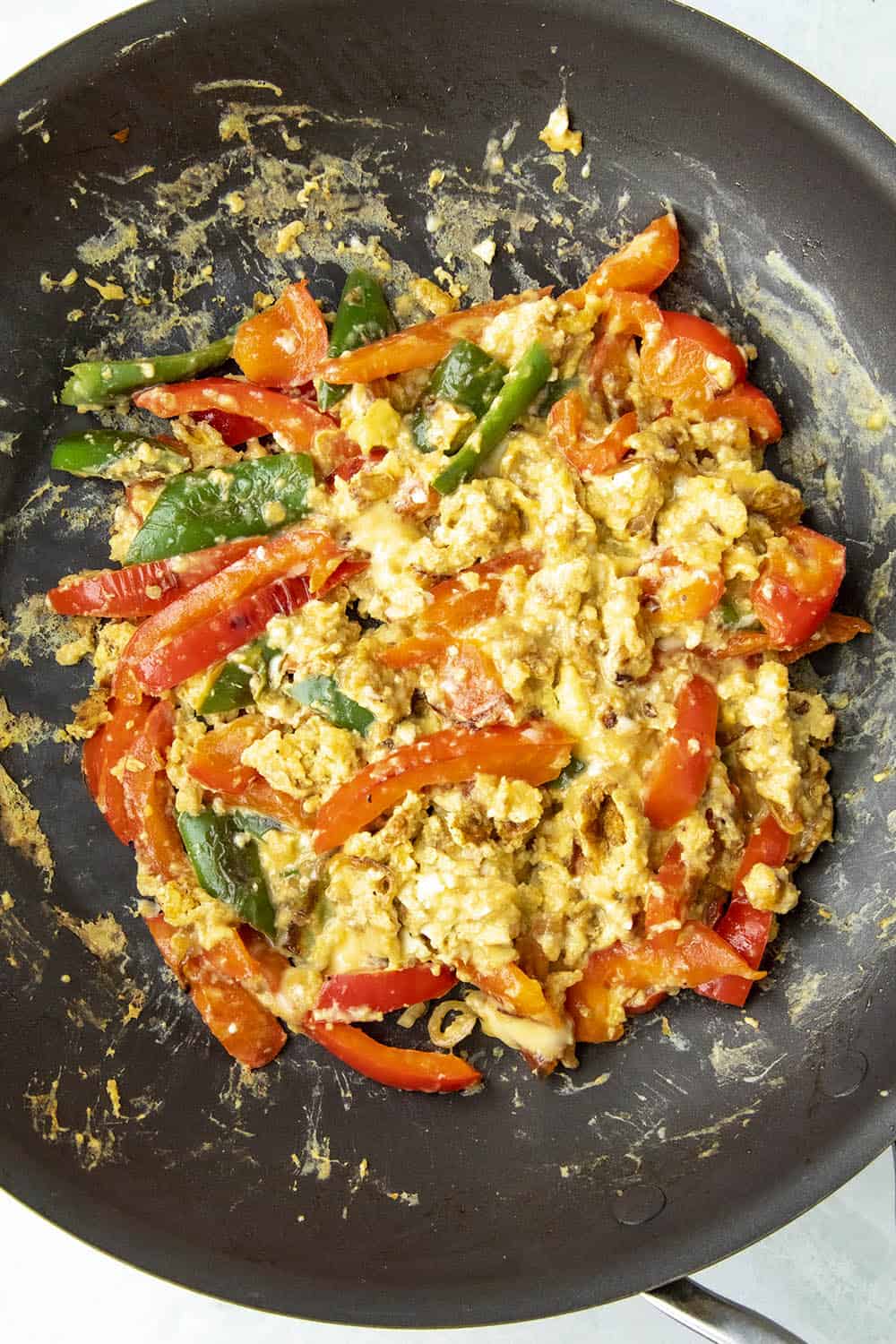 Scrambled eggs with peppers in a pan