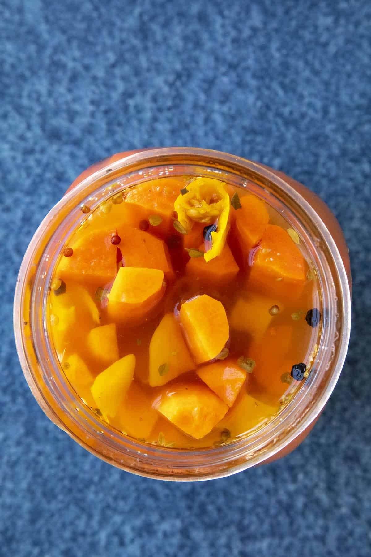 Pickled Carrots in a jar with hot peppers to make them spicy