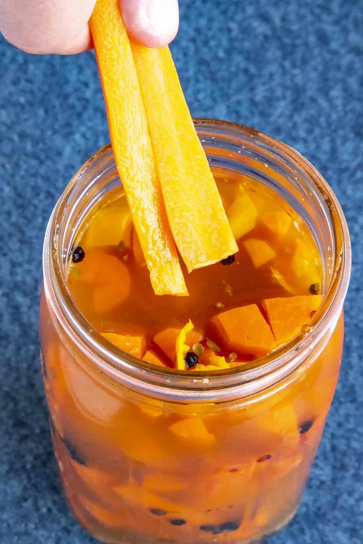 Mike taking some pickled carrots from the jar