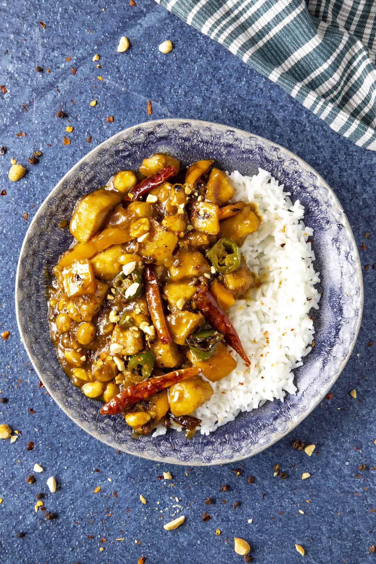 Szechuan Chicken on a plate, garnished with chili flakes