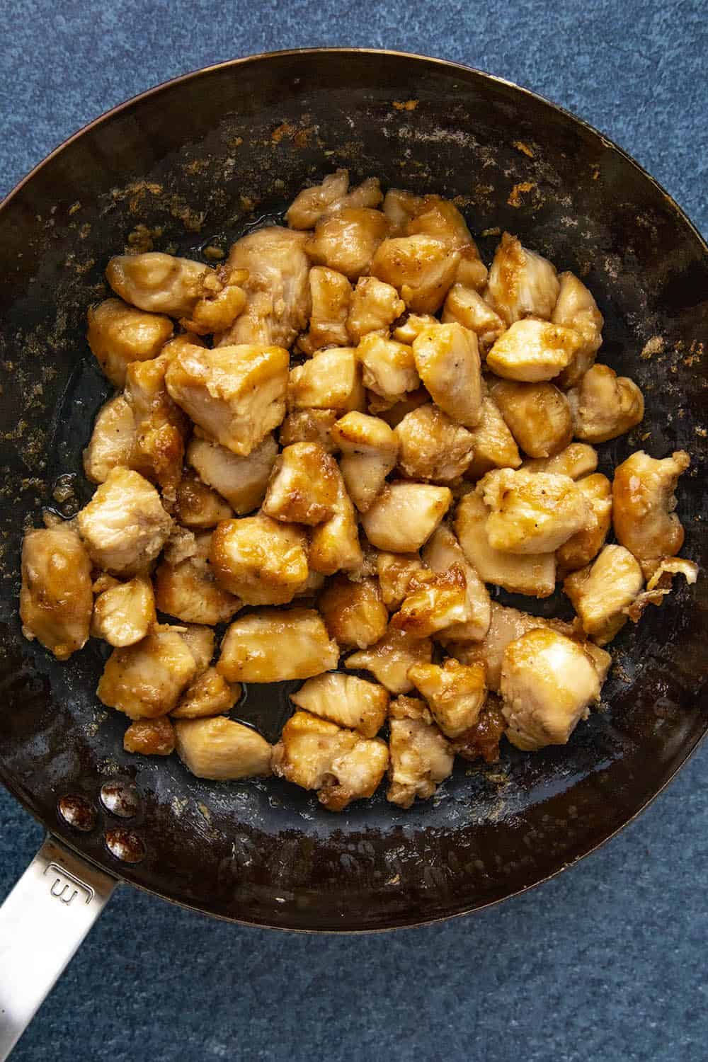 Cooking the seasoned chicken in a hot pan