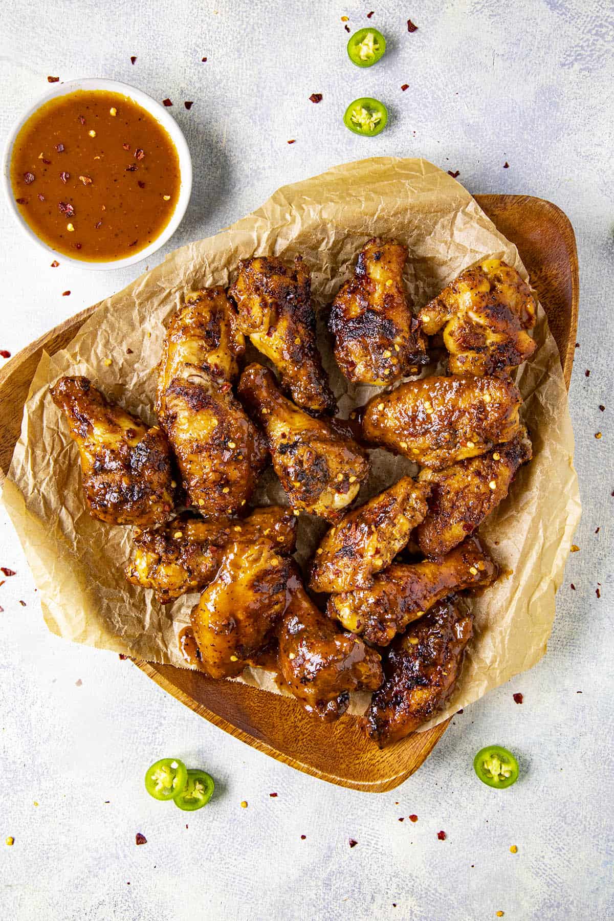Spicy BBQ Chicken Wings on a platter with lots of extra bbq sauce