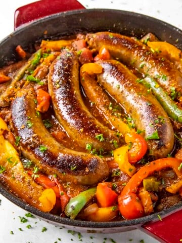 Sausage and Peppers served in a skillet.