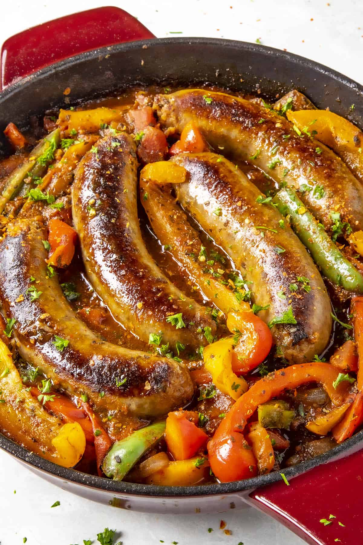 Sausage and Peppers sizzling in a pan.