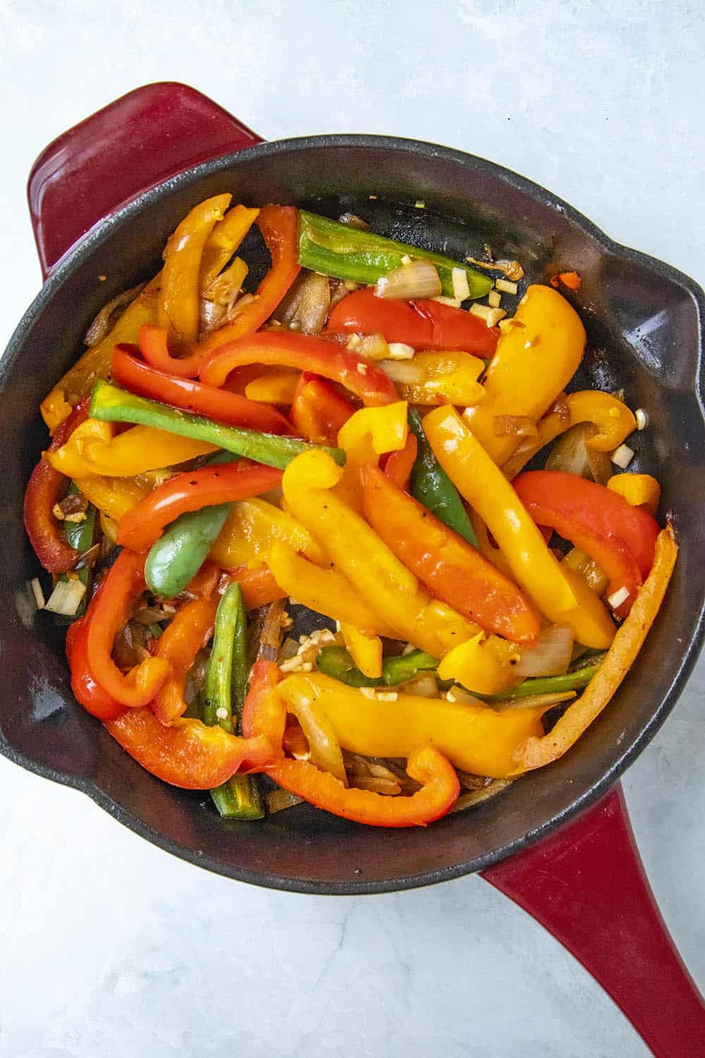 Cooking down the peppers.