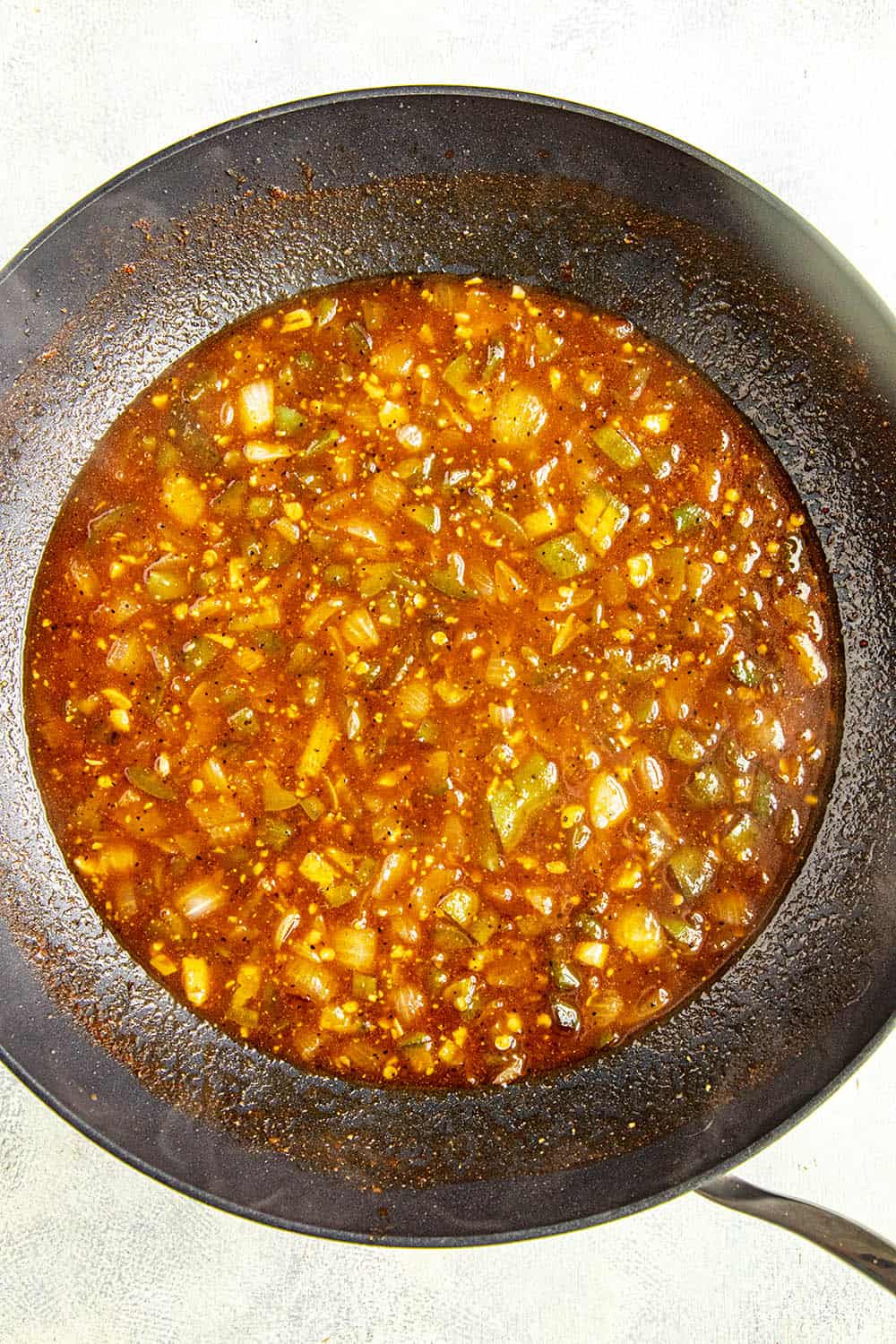 Simmering all of the ingredients in a pan to make bbq sauce