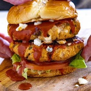 Holding one of the Buffalo Chicken Burgers