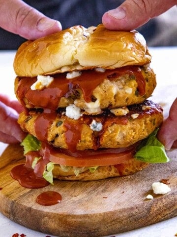 Holding one of the Buffalo Chicken Burgers