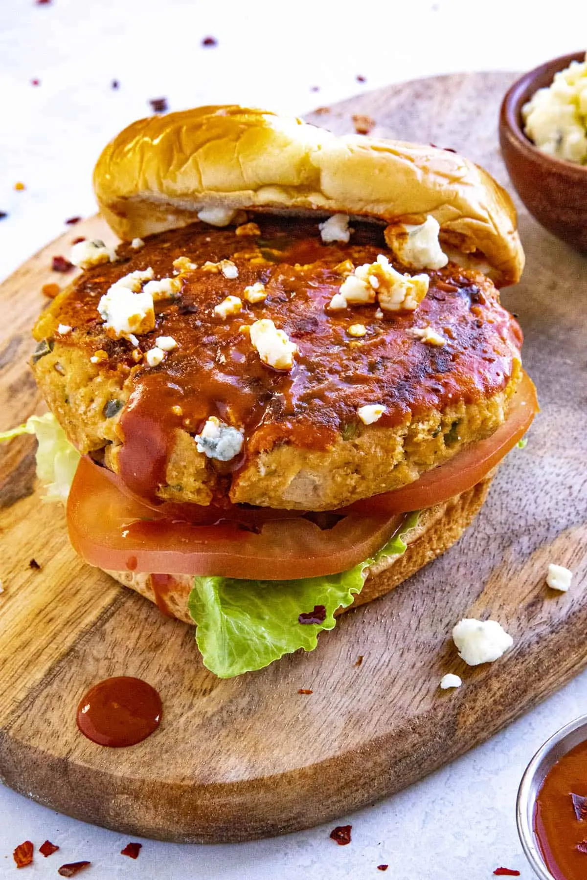 A Buffalo chicken burger with lots of crumbly blue cheese
