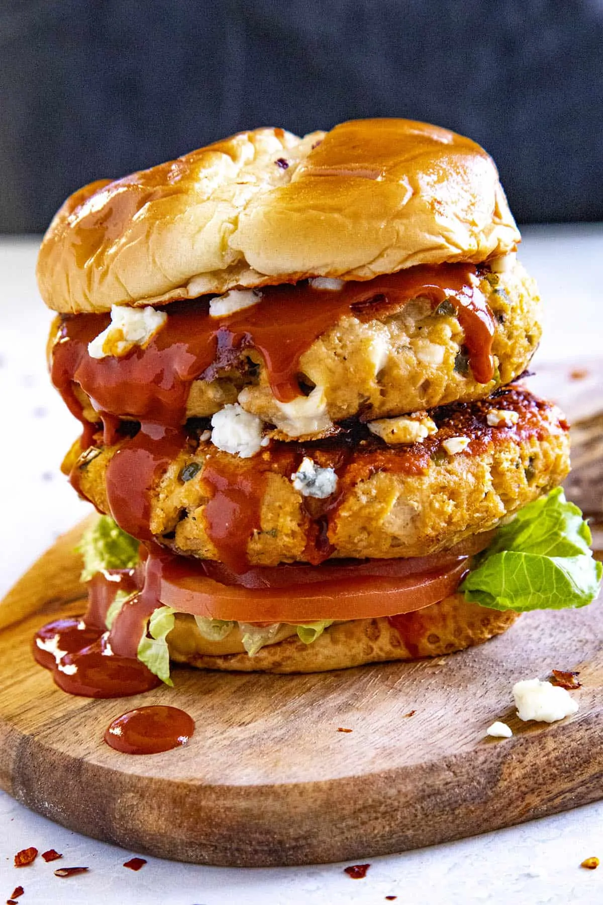 A double Buffalo chicken burger dripping with Buffalo sauce