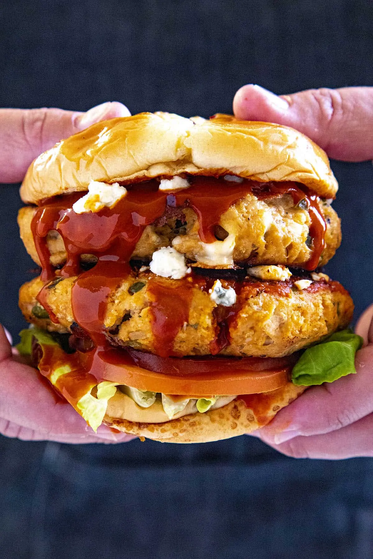 Mike holding a double Buffalo chicken burger