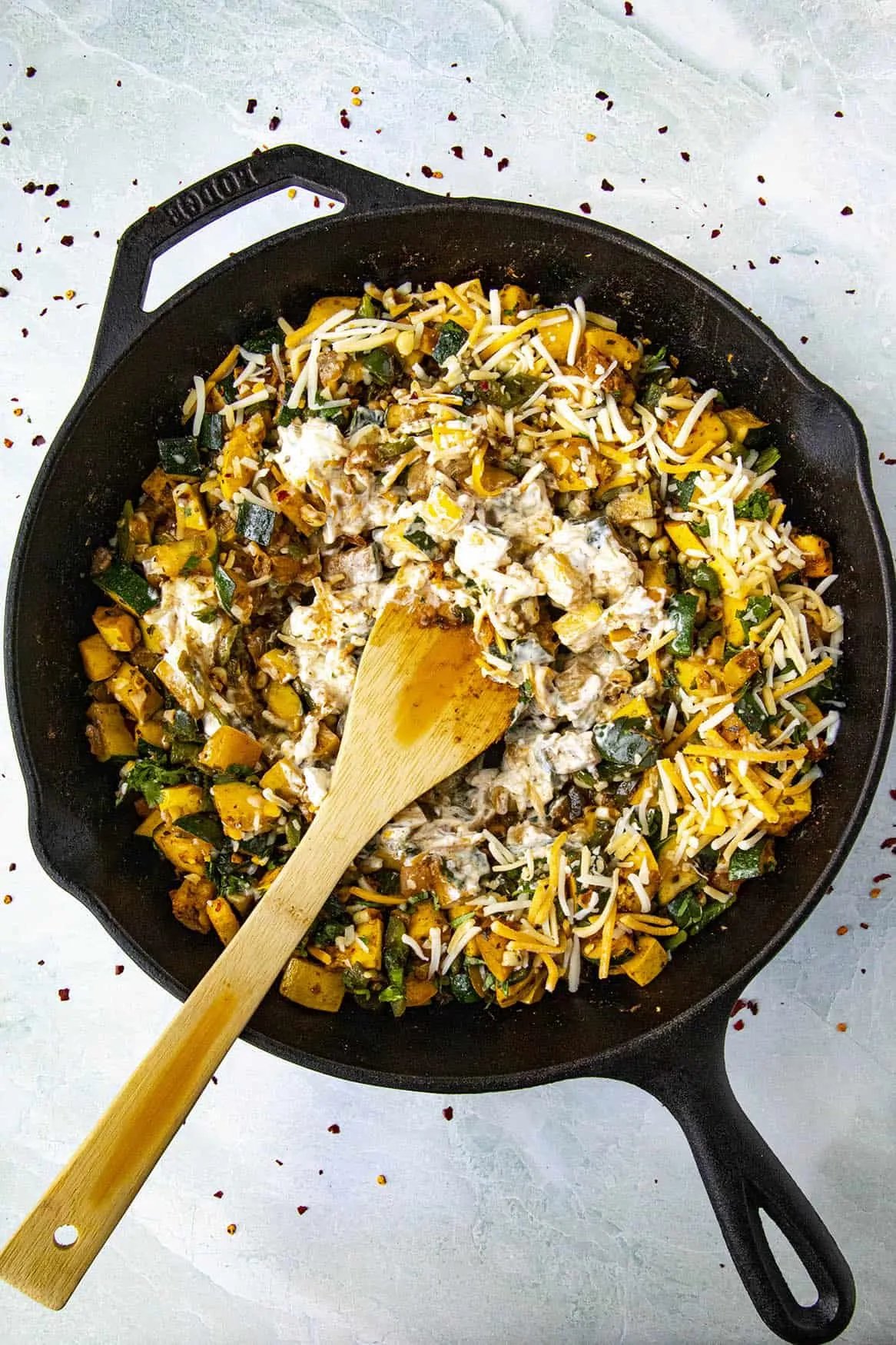 Adding cheese to the calabacitas