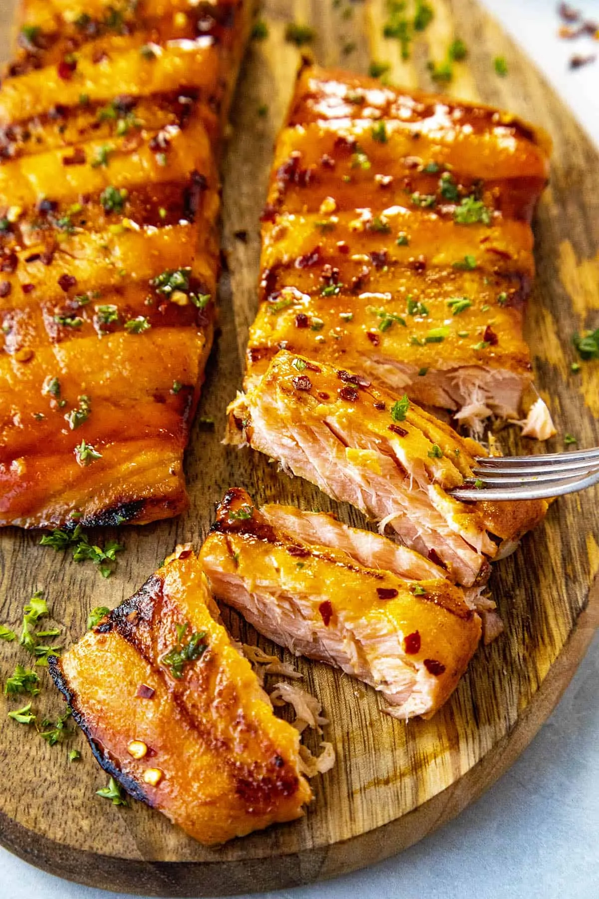 Taking a forkful of grilled salmon