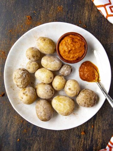 Papas Arrugadas (wrinkly potatos), on a plate with mojo picon