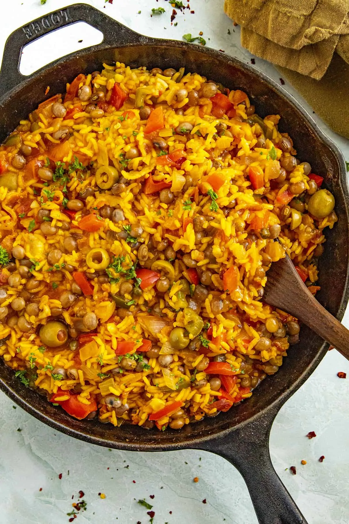 Scooping Arroz con Gandules from a pan