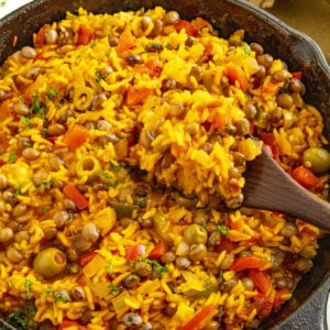 A large scoop of Puerto Rican Arroz con Gandules on a spoon