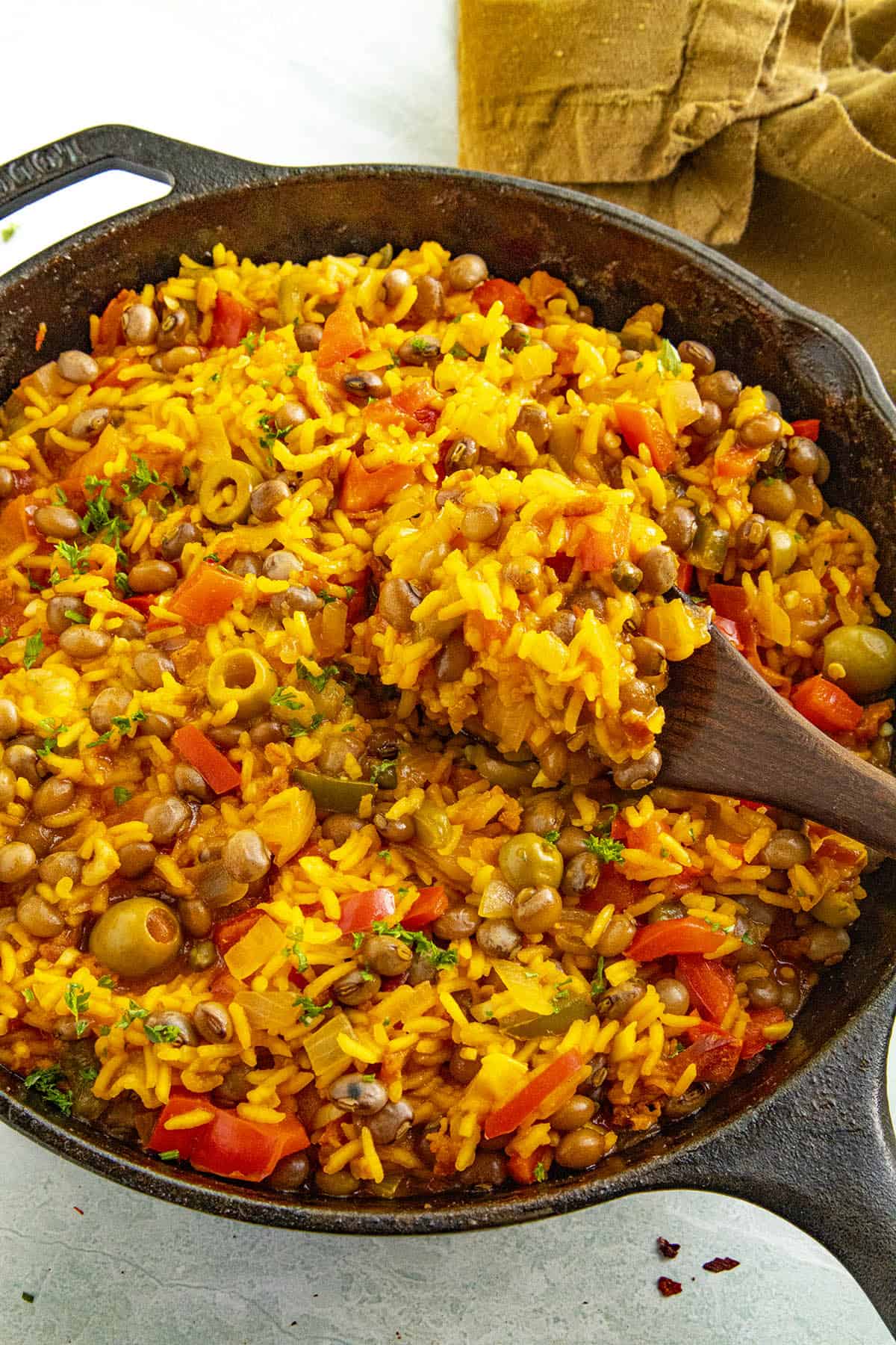 A large scoop of Puerto Rican Arroz con Gandules on a spoon