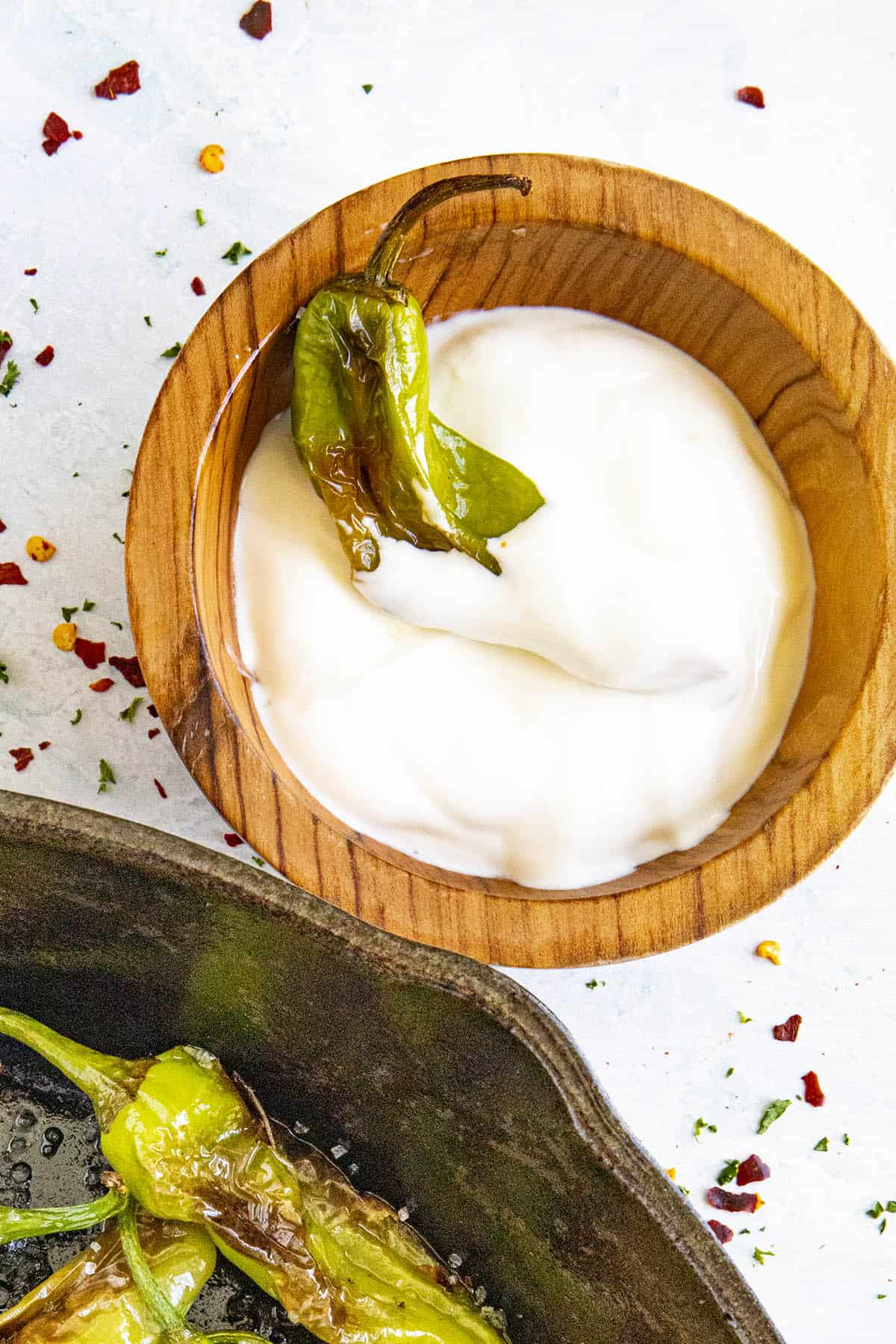 A Blistered Shishito Pepper dipped in lime-cream sauce