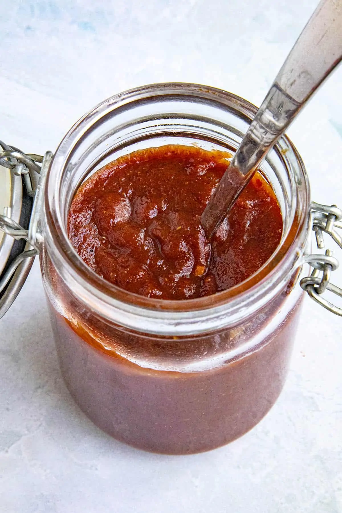 Homemade Chili Sauce in a jar with a spoon