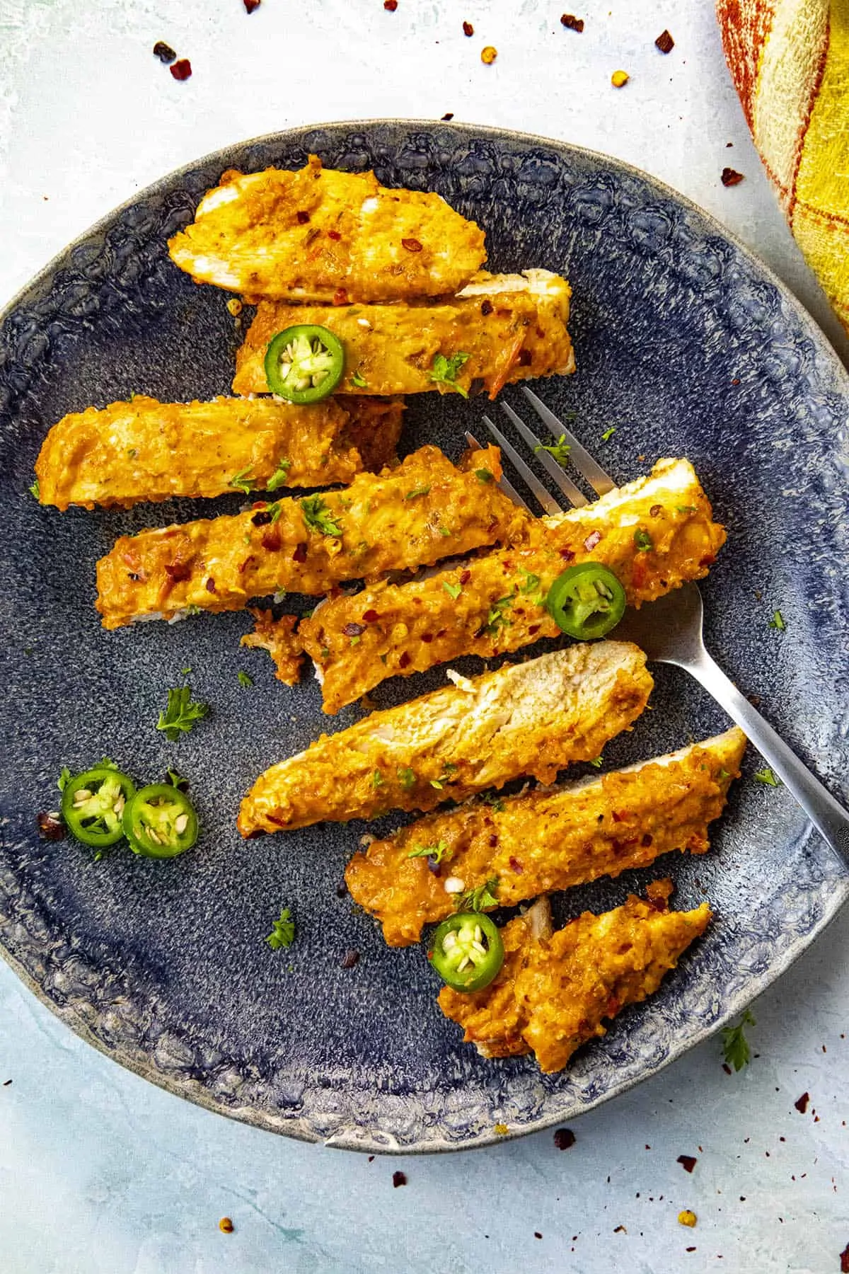 Slices of Baked Harissa Chicken Breast on a plate