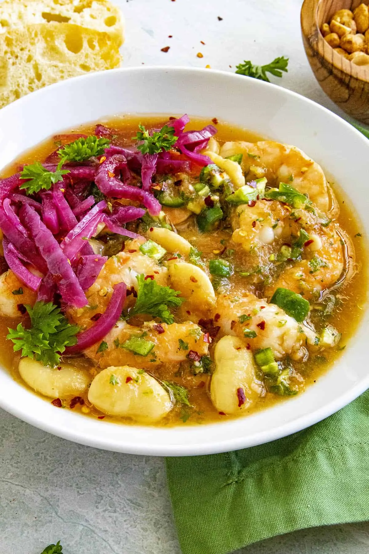 Shrimp Ceviche in a bowl, garnished with pickled red onion