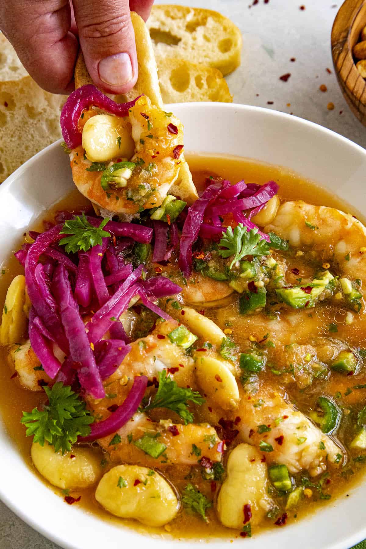 Mike dipping bread into shrimp ceviche