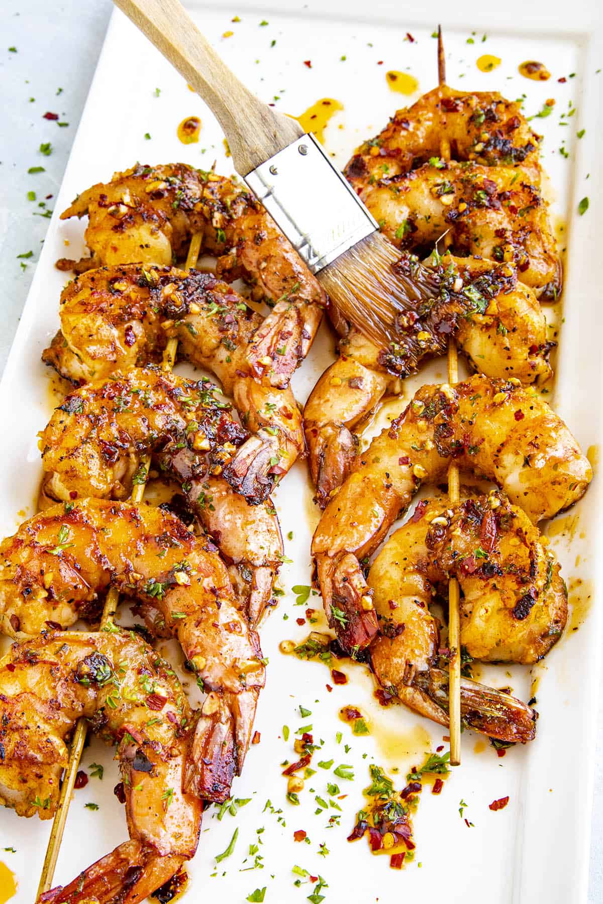 Basting shrimp with grilled shrimp marinade