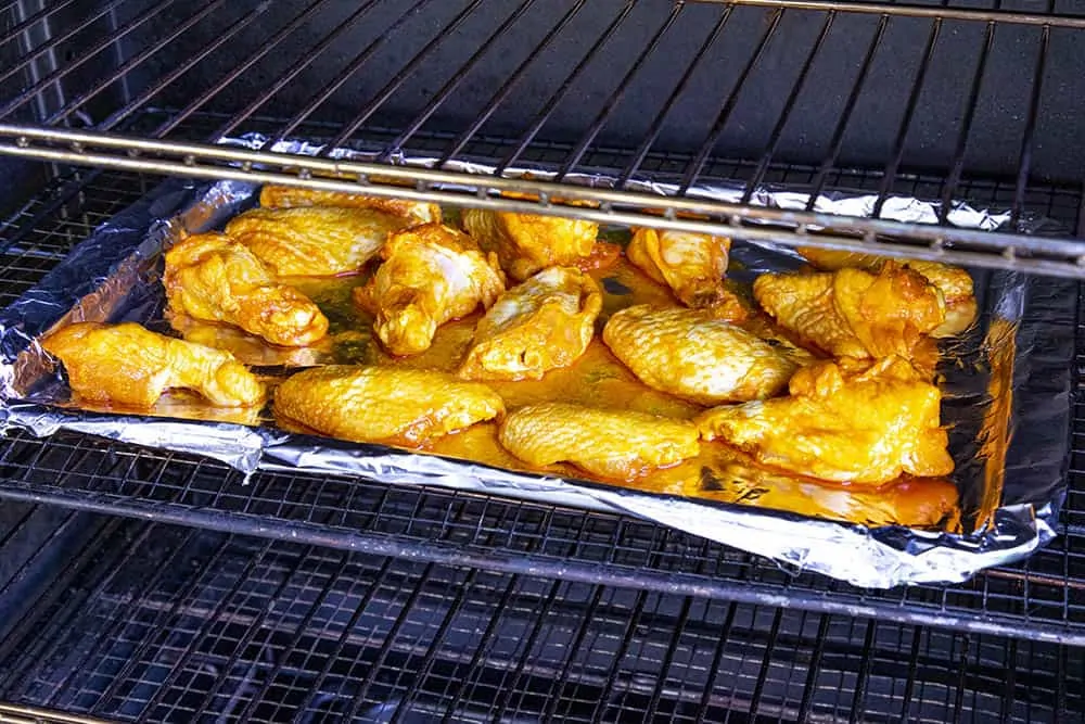 Loads of chicken wings in the smoker