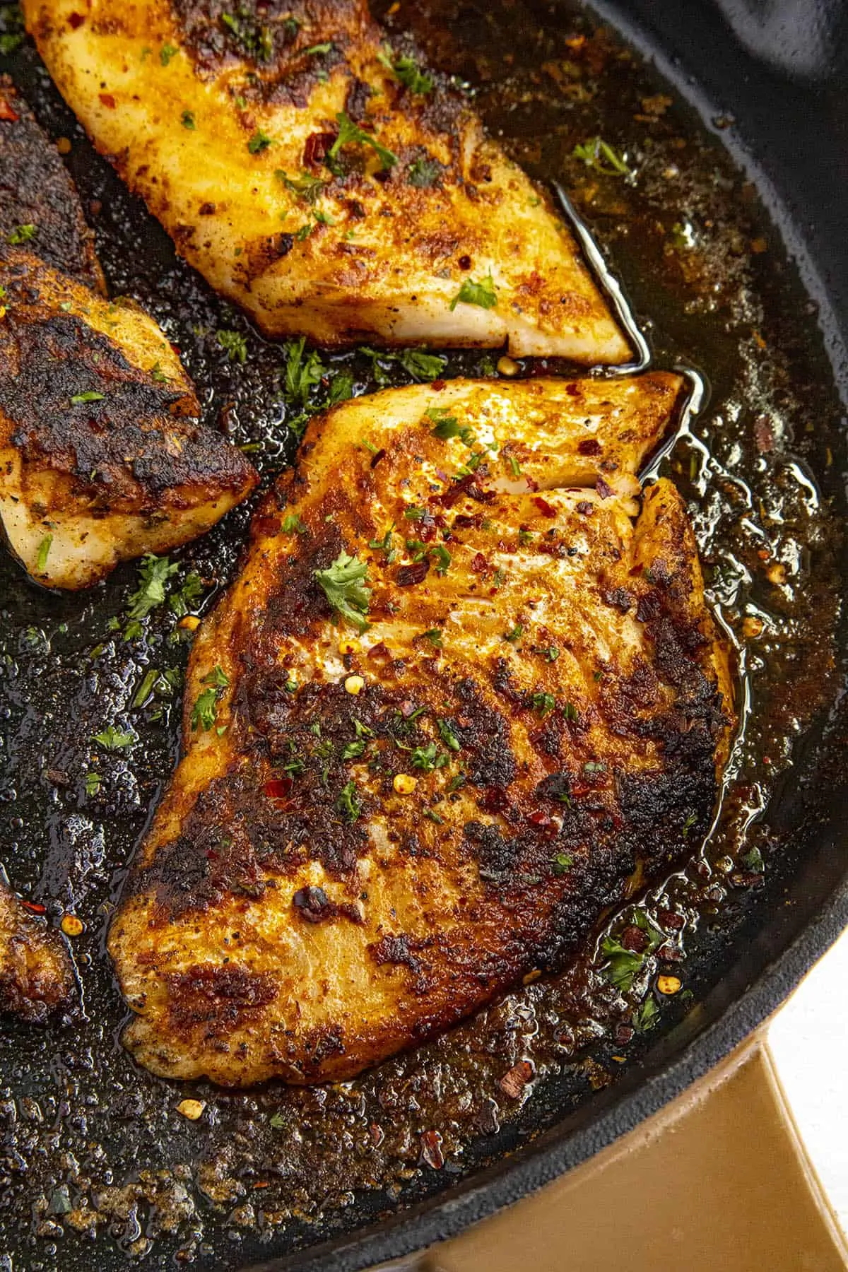 Spicy Blackened Fish in a pan.