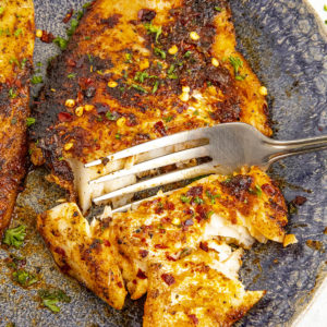 Taking a scoop with a fork of my spicy blackened fish