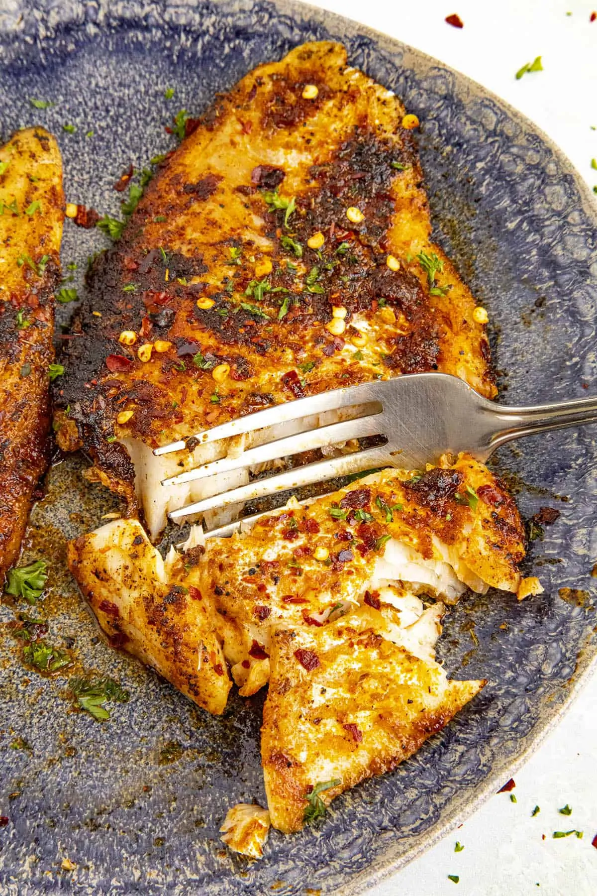 Taking a scoop with a fork of my spicy blackened fish