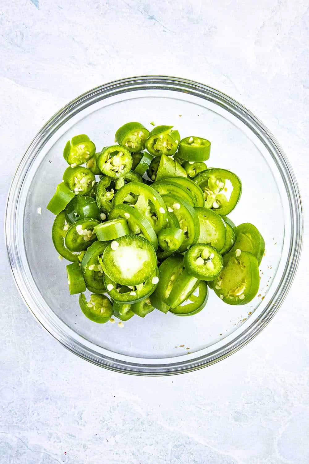 Sliced green peppers (jalapenos and serranos) in a bowl for making chilli pickle